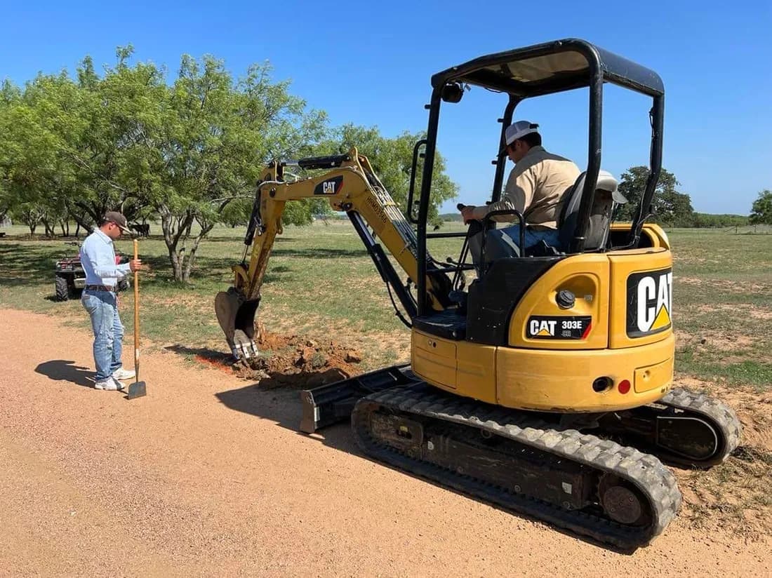 Setting fence posts with an auger on Colorado ranch land